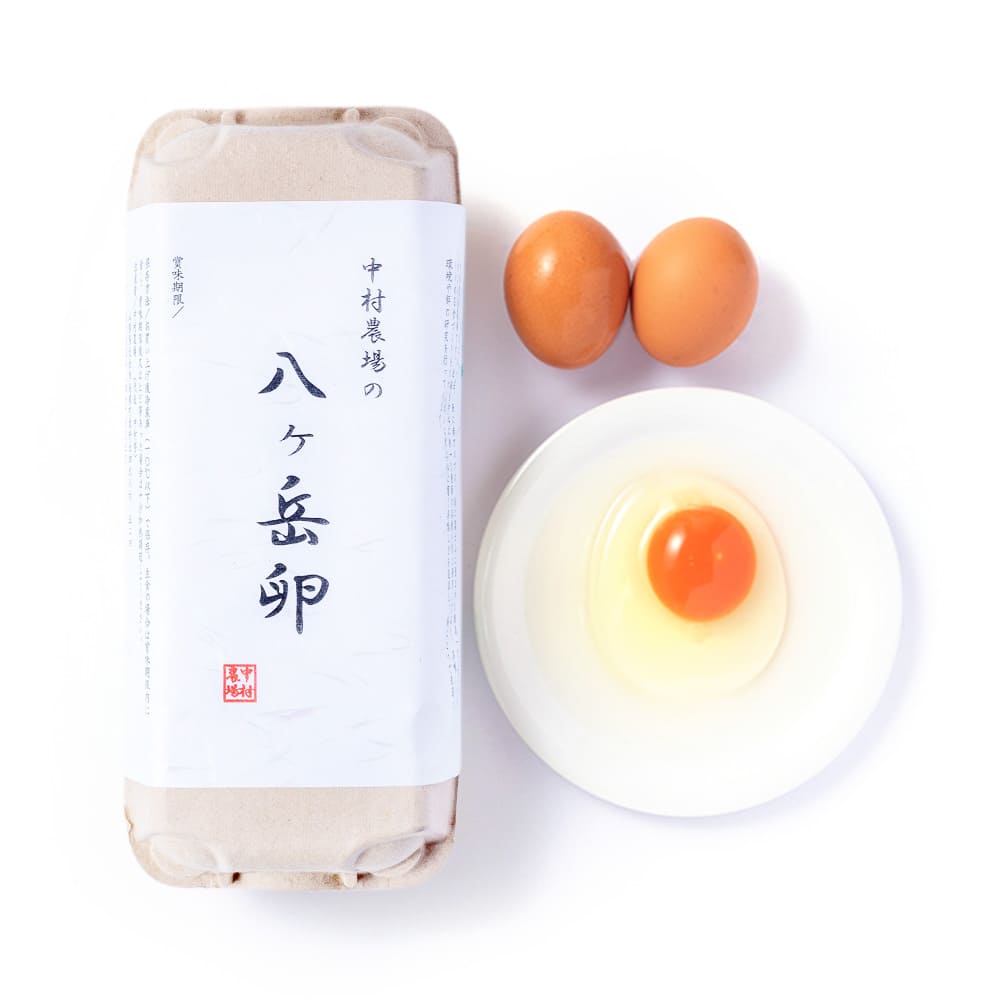 中村農場のブランド卵「八ヶ岳卵」のパッケージと、器に割り入れた生卵